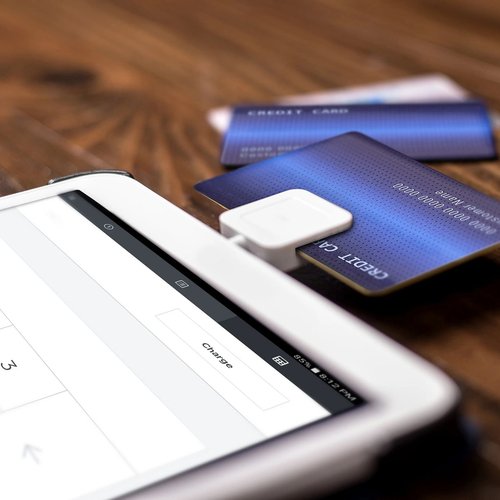Credit Card Being Swiped Through A Smart Device Card Reading Dongle
