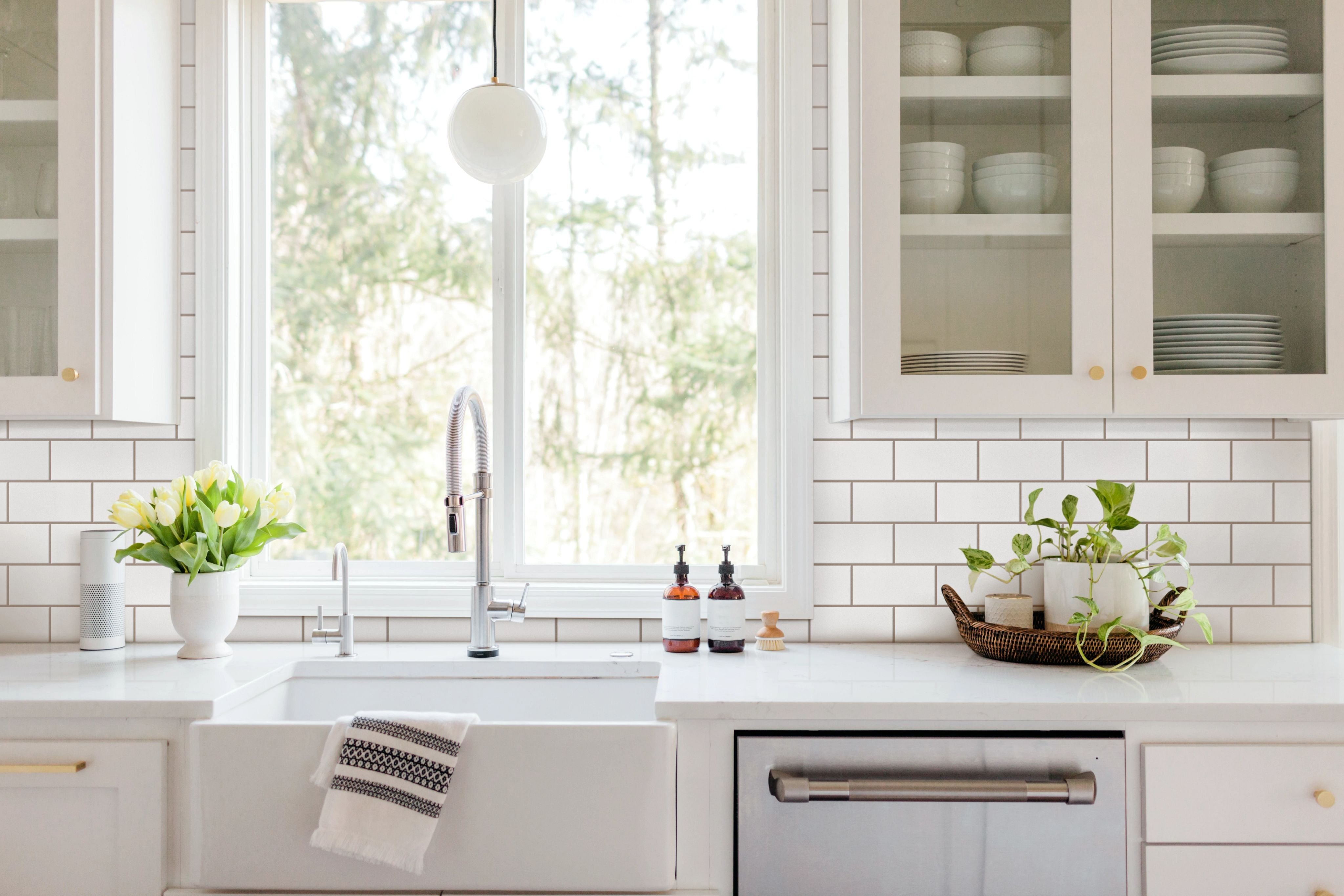 Bright And Spacious Kitchen with white cabinets and countertops from Grand Design Floors in Maple Grove, MN